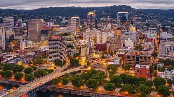 Downtown skyline at dusk with river bridge