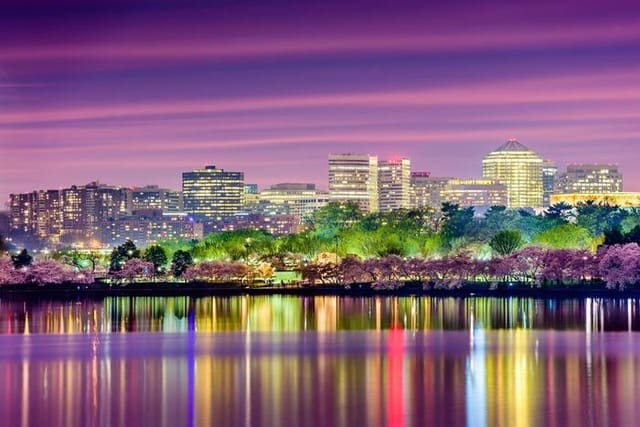 Purple sky city skyline reflected on calm water