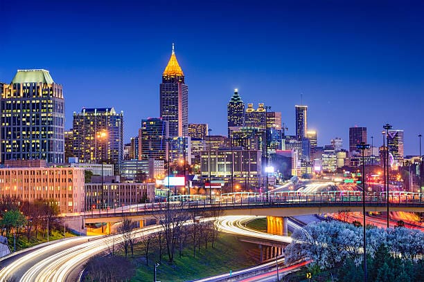 Nighttime Atlanta skyline with light trails